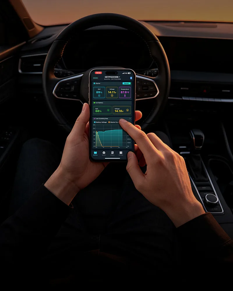 Driver checking BS200 battery data in the ANCEL app from the driver seat